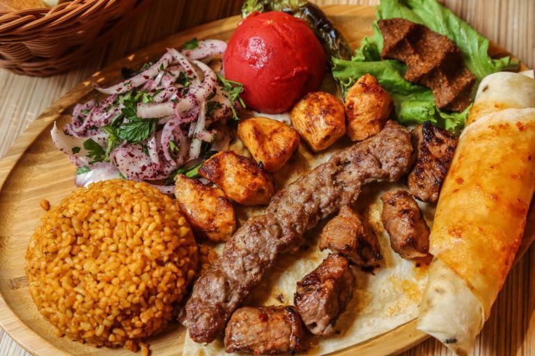 A mouth-watering close-up of an authentic Persian platter featuring freshly grilled beef koobideh, juicy chicken skewers, and fluffy saffron basmati rice from parkway kabab moorpark.