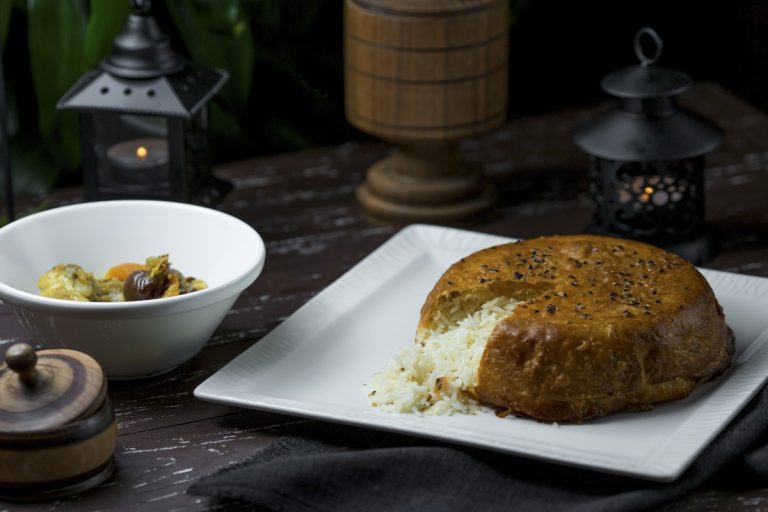 Golden crispy saffron rice crust flipped onto a serving platter showing how to make Persian tahdig.